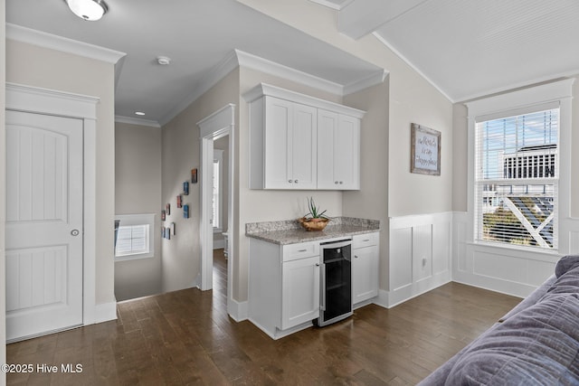 kitchen with beverage cooler, white cabinets, dark hardwood / wood-style flooring, and ornamental molding