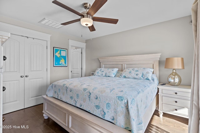 bedroom featuring ceiling fan, a closet, and dark hardwood / wood-style floors