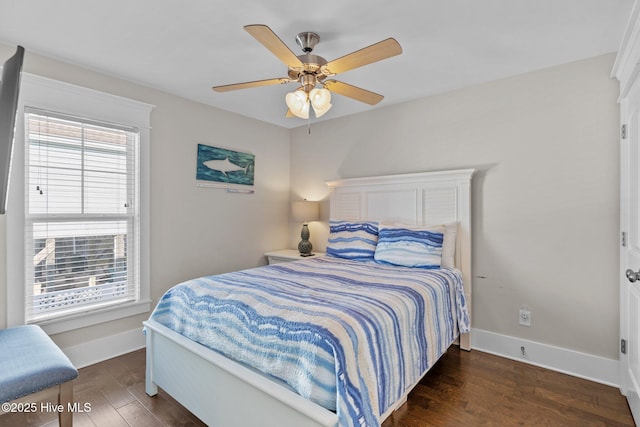 bedroom with ceiling fan and dark hardwood / wood-style flooring