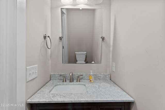 bathroom featuring toilet and vanity