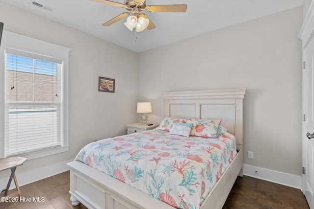 bedroom with ceiling fan and dark wood-type flooring