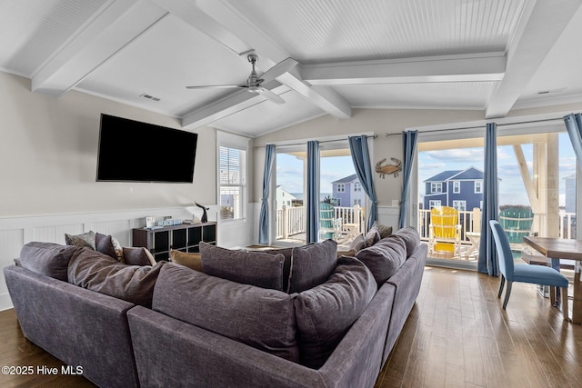 living room with ceiling fan, vaulted ceiling with beams, and hardwood / wood-style flooring