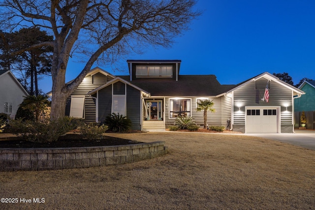 view of front of house with a garage and a front lawn