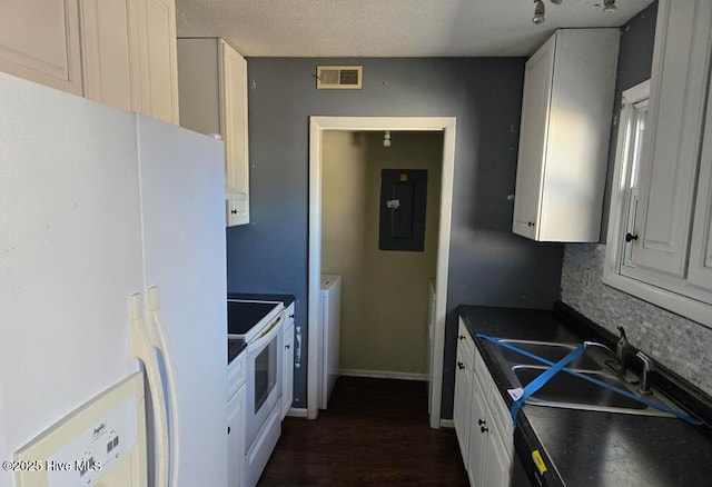 kitchen featuring white appliances, electric panel, tasteful backsplash, white cabinetry, and sink