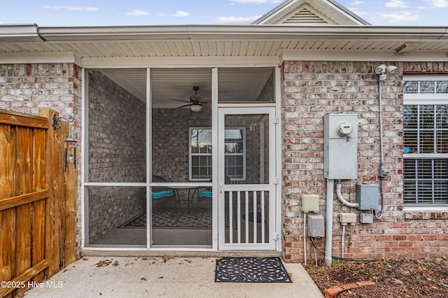 view of exterior entry featuring ceiling fan