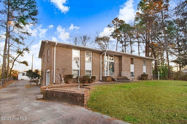 102 Circle Dr, Snow Hill, NC 28580 - view of front of house with a front yard, brick siding, driveway, and an attached garage