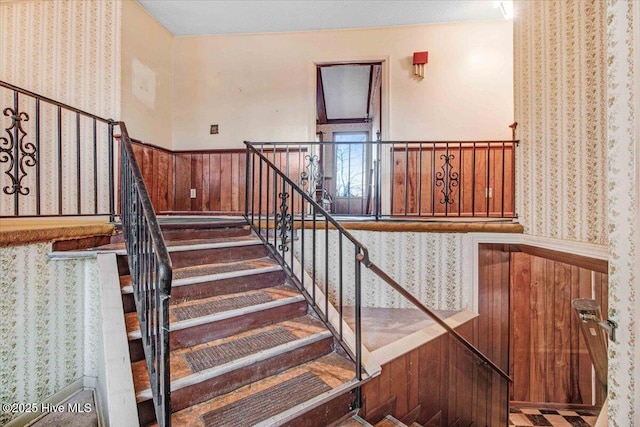 stairs featuring wooden walls