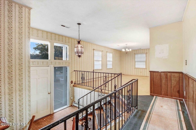 hallway featuring a notable chandelier