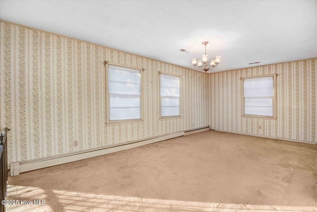 carpeted spare room with an inviting chandelier and a baseboard radiator