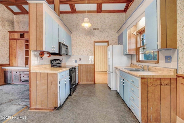 kitchen featuring sink, beamed ceiling, backsplash, hanging light fixtures, and black appliances