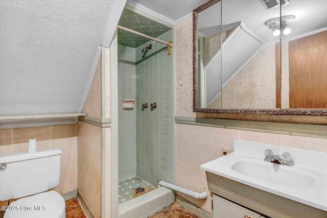 bathroom featuring crown molding, a tile shower, vanity, and toilet