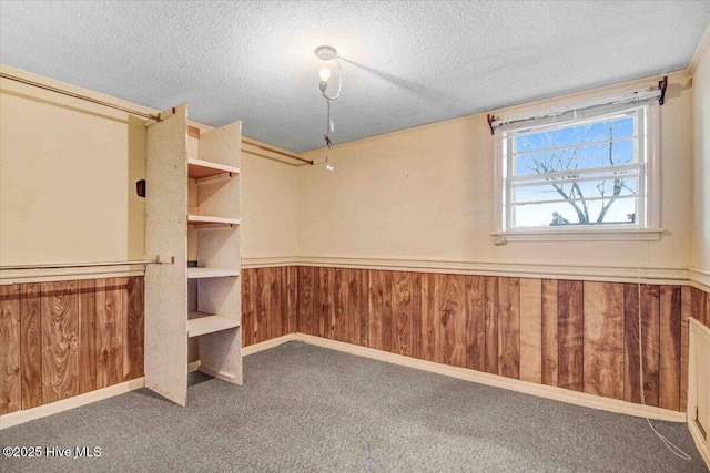 interior space with a textured ceiling and carpet floors