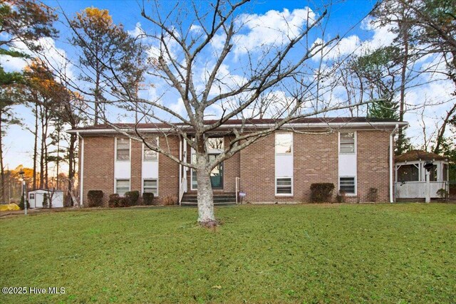102 Circle Dr, Snow Hill, NC 28580 - back of house featuring a lawn and brick siding