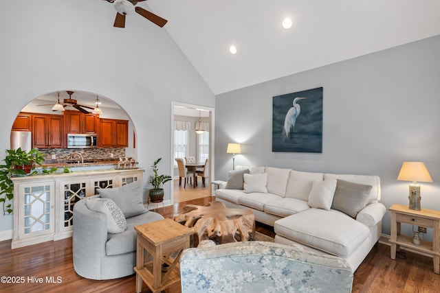 living room featuring sink, high vaulted ceiling, ceiling fan, and hardwood / wood-style floors