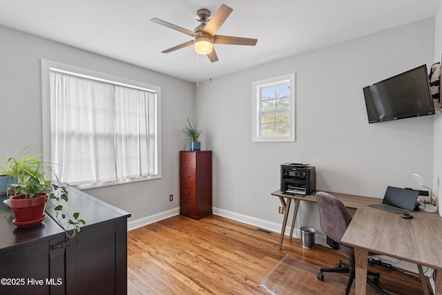 office area with light hardwood / wood-style floors and ceiling fan