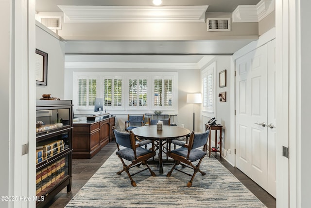 dining room featuring dark hardwood / wood-style flooring and ornamental molding