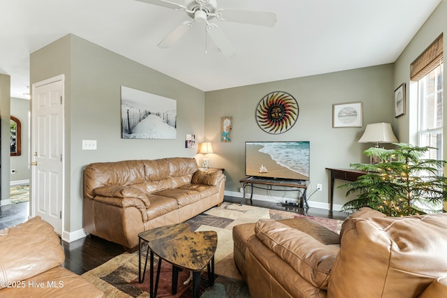 living room featuring ceiling fan and dark hardwood / wood-style floors