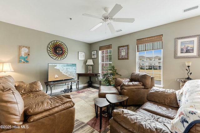 living room with ceiling fan and plenty of natural light