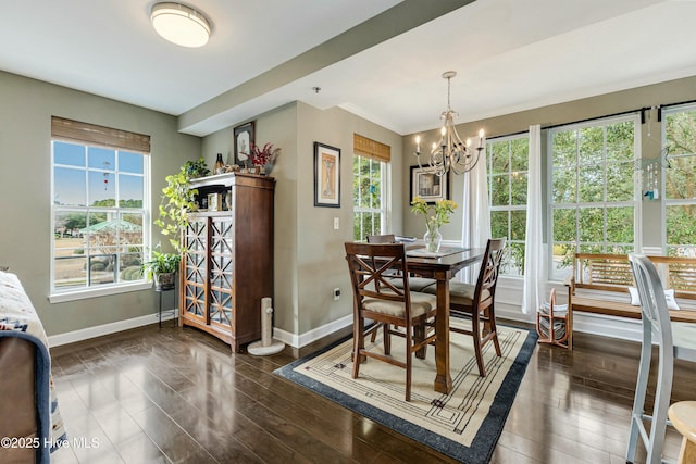 dining area featuring a wealth of natural light, dark hardwood / wood-style flooring, and an inviting chandelier