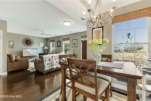 dining space featuring ceiling fan with notable chandelier and hardwood / wood-style flooring