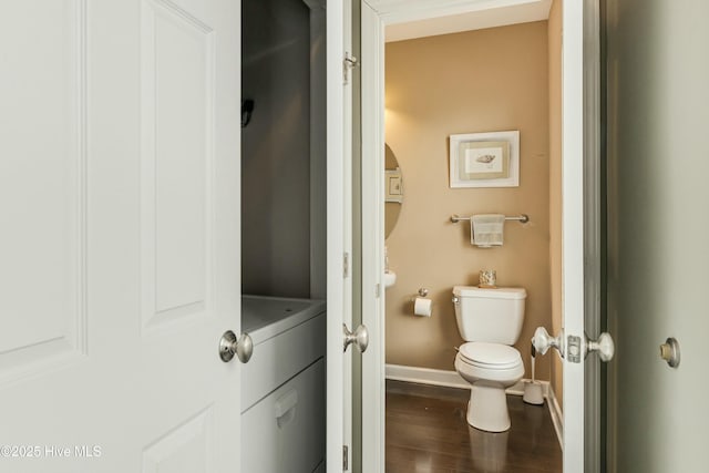 bathroom with toilet and hardwood / wood-style floors