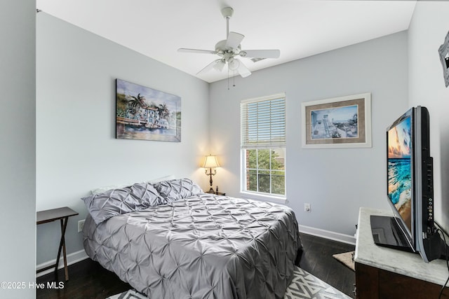 bedroom featuring ceiling fan and dark hardwood / wood-style floors