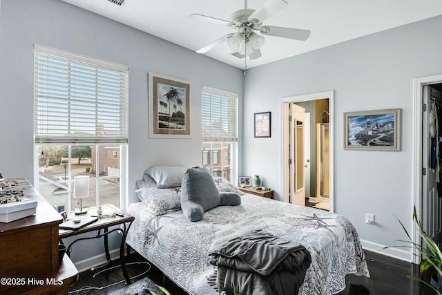 bedroom featuring ceiling fan, dark hardwood / wood-style flooring, and ensuite bath