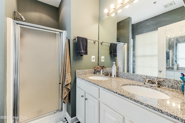 bathroom with walk in shower and vanity