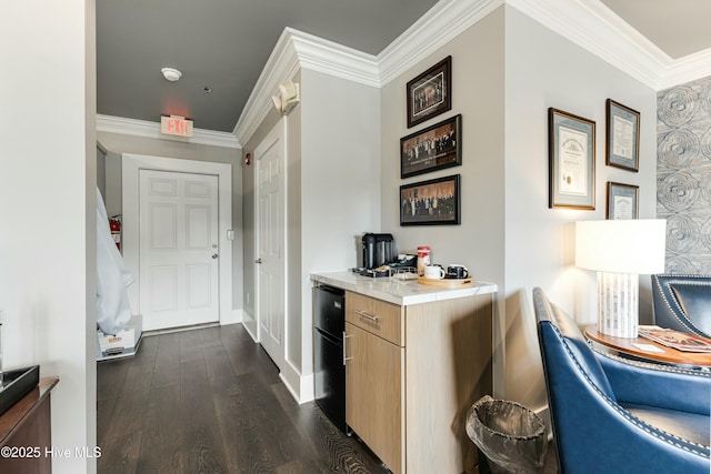 kitchen with light brown cabinets, dark wood-type flooring, and crown molding