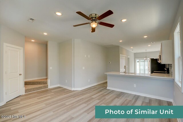 kitchen featuring refrigerator, recessed lighting, a ceiling fan, and light wood-style floors