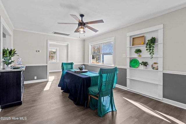 dining area featuring ornamental molding, dark wood-type flooring, and ceiling fan