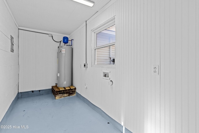 basement featuring wooden walls and water heater