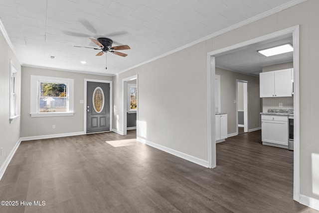 foyer with dark wood-type flooring, ceiling fan, and crown molding