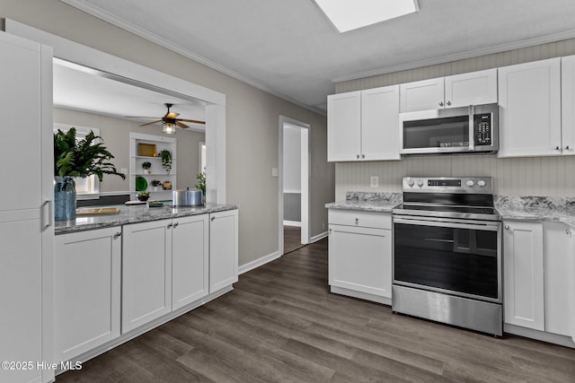 kitchen with appliances with stainless steel finishes, white cabinets, ceiling fan, crown molding, and dark wood-type flooring