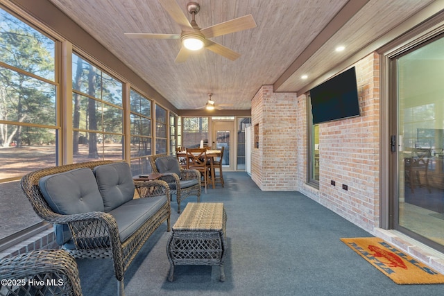 sunroom with ceiling fan and wood ceiling