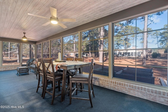 sunroom with ceiling fan and wooden ceiling