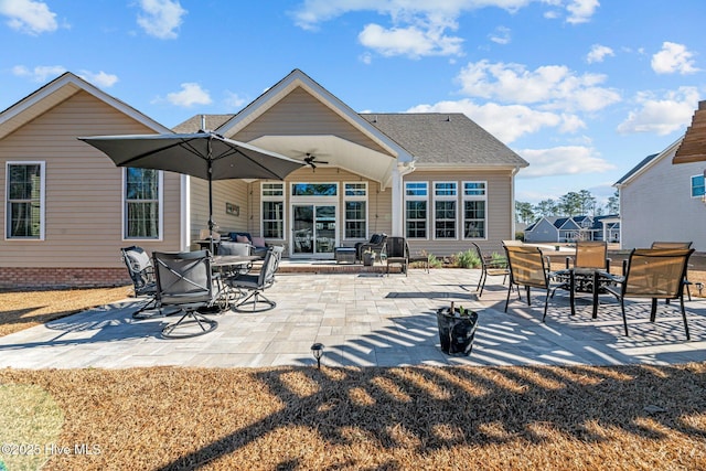 rear view of property featuring ceiling fan and a patio