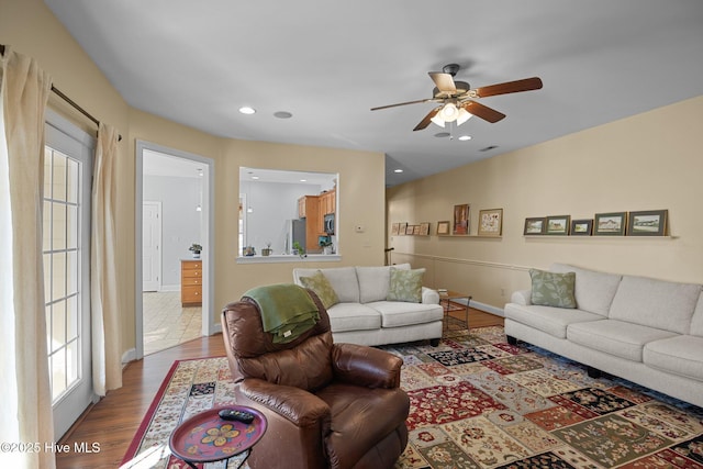 living room with hardwood / wood-style flooring and ceiling fan