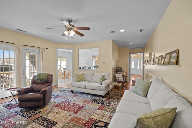 living room featuring ceiling fan and hardwood / wood-style flooring