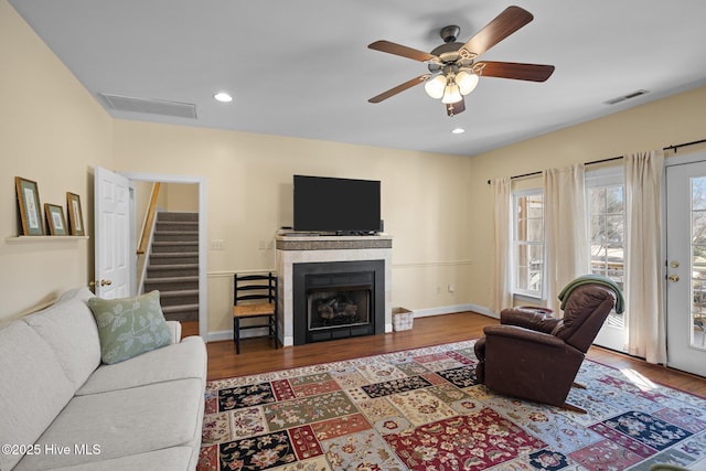 living room featuring hardwood / wood-style floors and ceiling fan