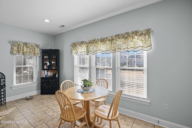 tiled dining space with a healthy amount of sunlight