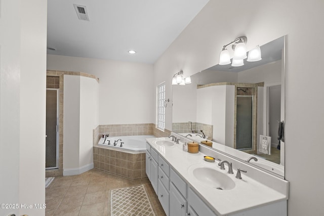 bathroom with independent shower and bath, tile patterned flooring, and vanity