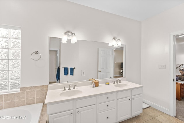 bathroom featuring a tub to relax in, tile patterned flooring, and vanity