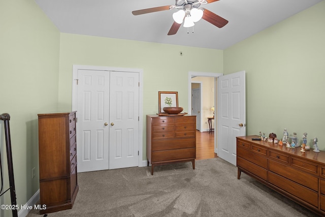 carpeted bedroom featuring ceiling fan and a closet