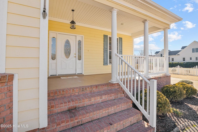 view of exterior entry with covered porch