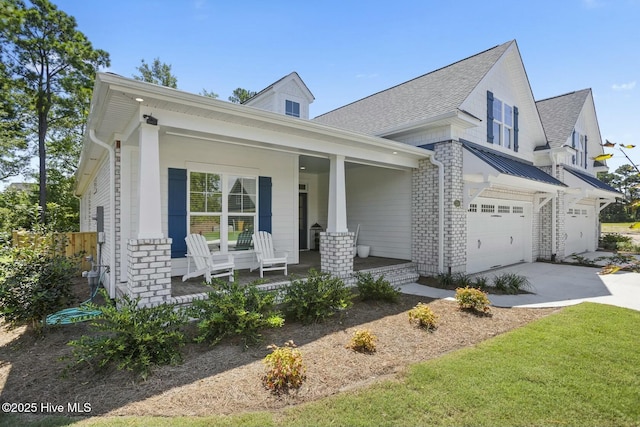 view of front of property featuring covered porch and a garage