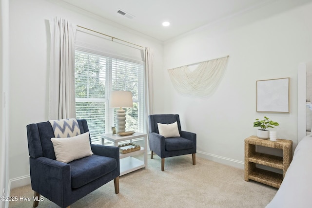 living area featuring light colored carpet and ornamental molding