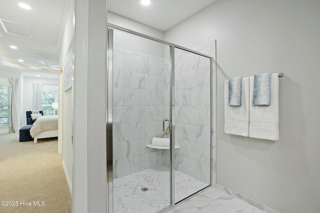 bathroom featuring a shower with door