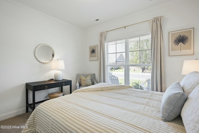 bedroom with carpet floors and crown molding