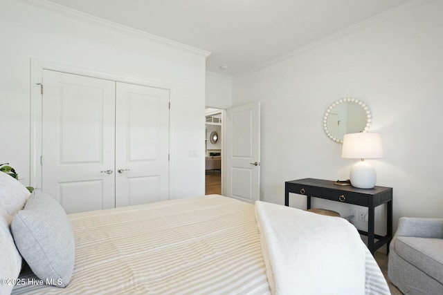 bedroom featuring a closet and crown molding